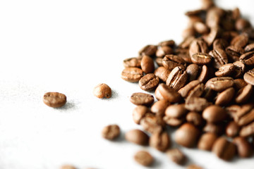 Coffee beans on light wooden background with copyspace for text. Coffee background, food frame, texture concept. Banner