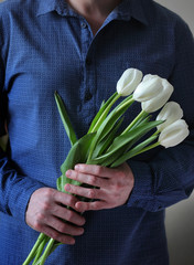Men's hands hold flowers. Man with flowers. Flowers for your beloved woman.
A bouquet in hands....