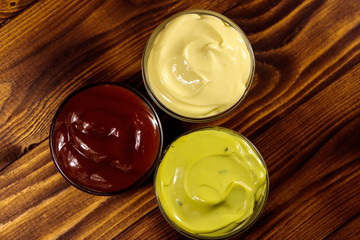 Set of sauces on wooden table