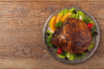 Baked ham, served on an old plate.