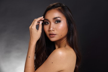 Obraz premium Asian Long straight black hair tan skin woman in Black dress