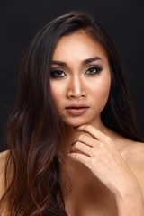 Obraz premium Asian Long straight black hair tan skin woman in Black dress