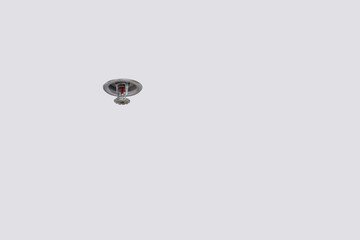 Smoke detector and pendent fire sprinkler on a ceiling,fire emergency