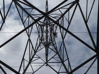 An electrical tower viewed from underneath the tower