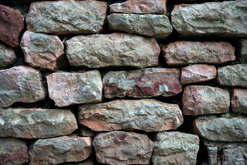 Stone wall. Gently stacked on each other stones. Background image. Concept wallpaper