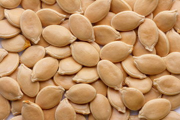 a bunch of pumpkin seeds, top view closeup