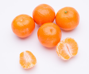 Whole and half of mandarin oranges isolated on white background