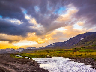 Beautiful sunrise over mountain and a small stream