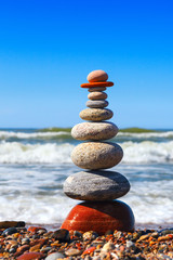 Concept of harmony and tranquility. Rock Zen near the sea