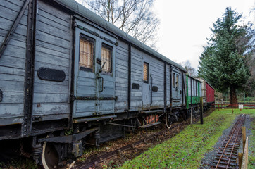 Fototapeta na wymiar A line of old, disused wooden railway carriages