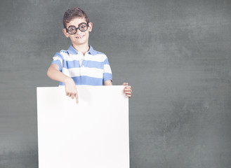 Funny little geek boy holding a white blank sign with copy space