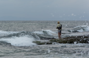 Fisherman in the stormy sea