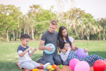 Fototapeta premium Young family with children having fun in nature