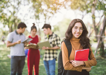 education, campus, friendship and people concept - group of happy asian teenage students with school folders