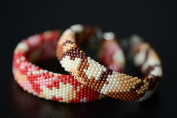 Two camouflage bracelets on a dark background close up