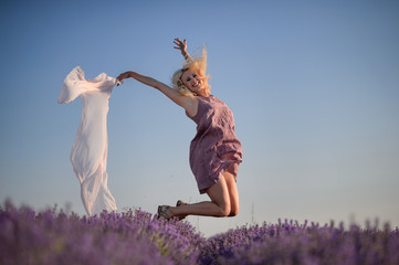 Beautiful girl in a field of lavender on sunset.