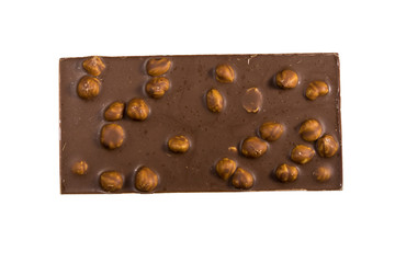 Milk chocolate bar with hazelnuts isolated on white background
