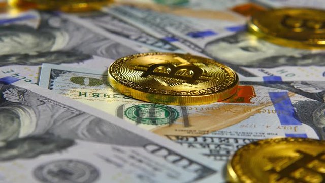 Gold coins of bitcoins and a background of hundred-dollar bills. The concept of financial operations. Economy of the future