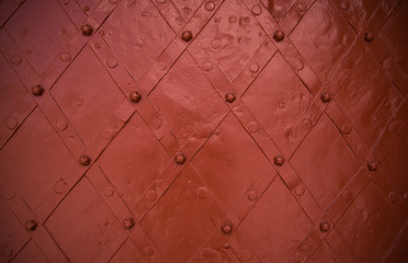 Red brown metal door rhomboid close-up background