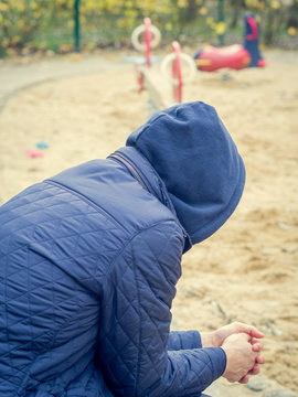 Lonley divorced man looking at a playground with no children