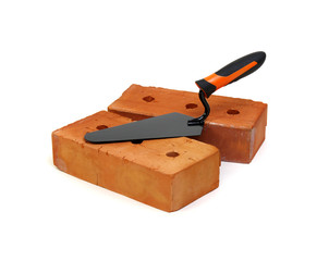 Brick and trowel on a white