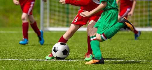 Obraz premium Running Young Soccer Football Players. Footballers Kicking Football Match Game. Youth Soccer Players Running the Ball. Soccer Teams School Tournament