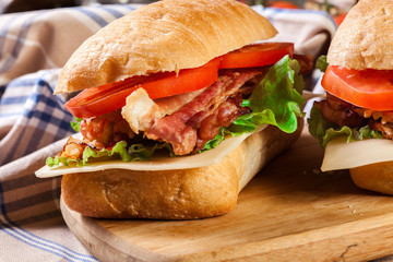 Ciabatta sandwich with smoked bacon, cheese and tomato
