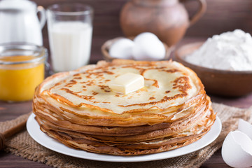 Traditional Ukrainian or Russian pancakes on a plate with butter. Russian bliny.