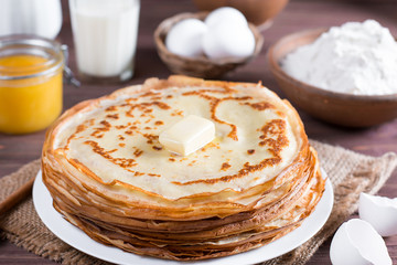 Traditional Ukrainian or Russian pancakes on a plate with butter. Russian bliny.