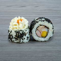 Sushi rolls on a wooden gray background