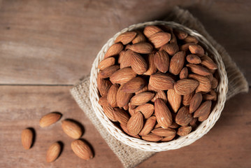 Almond snack fruit in white bowl on wooden