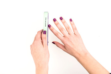 Woman Hands Doing Her Nails On White Background