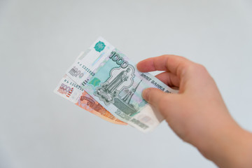 a woman's hand holds a five thousandth note. Russian money.