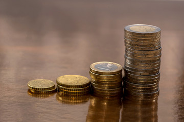 a set of euro coins allocated on a golden background