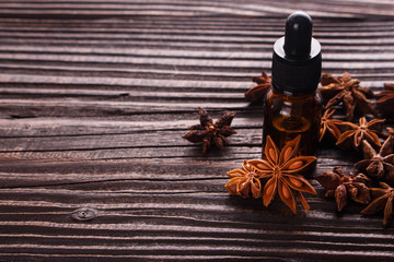 essential oil of the anise stars on a dark rustic background