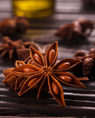 essential oil of the anise stars on a dark rustic background