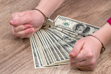 female holds money dollars in handcuffed