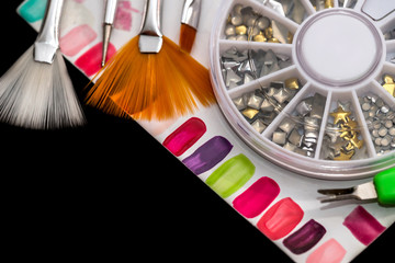 samples of colored false nails, crystals