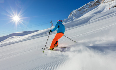 Young man skiing downhill in Alps