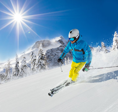 Young man skiing downhill in Alps