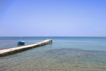 Fototapeta na wymiar Small pier on the beach of Corfu Island