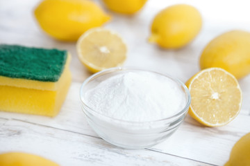 Baking soda and lemon on wooden table