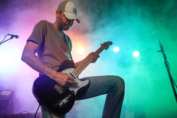 The guitarist performs on stage.