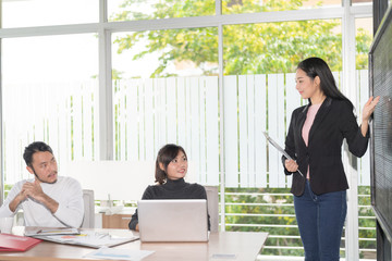 Business people making presentation with the colleagues and business tablet digital computer at the office. Setup studio shooting..