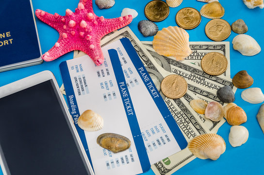 ticket with passport and dolls bills on blue