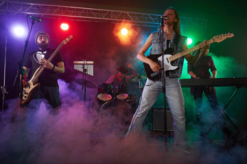 Guitarist and bass player perform on stage.