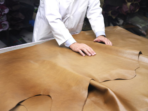 leather goods manufacturer showing his leather