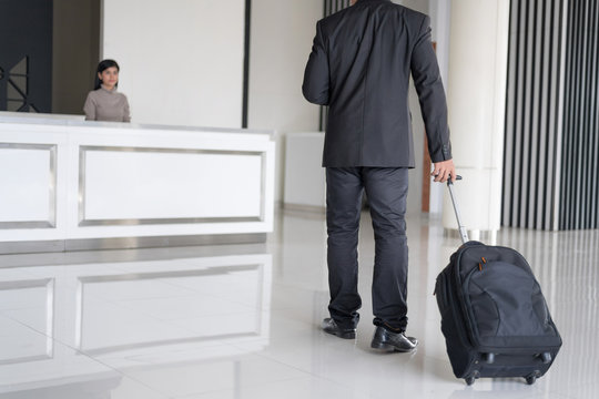 Man In Hotel Check In At Reception Or Front Office Being Given Key Card. Setup Studio Shooting.