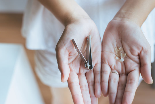 Woman cutting nails with nail clipper,Female using tweezers