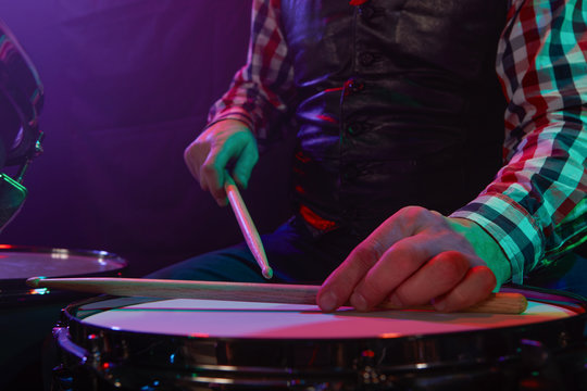 The drummer plays on a small drum.